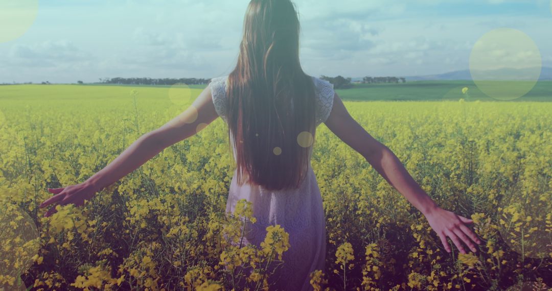 Woman with Outstretched Arms in Serene Flower Field