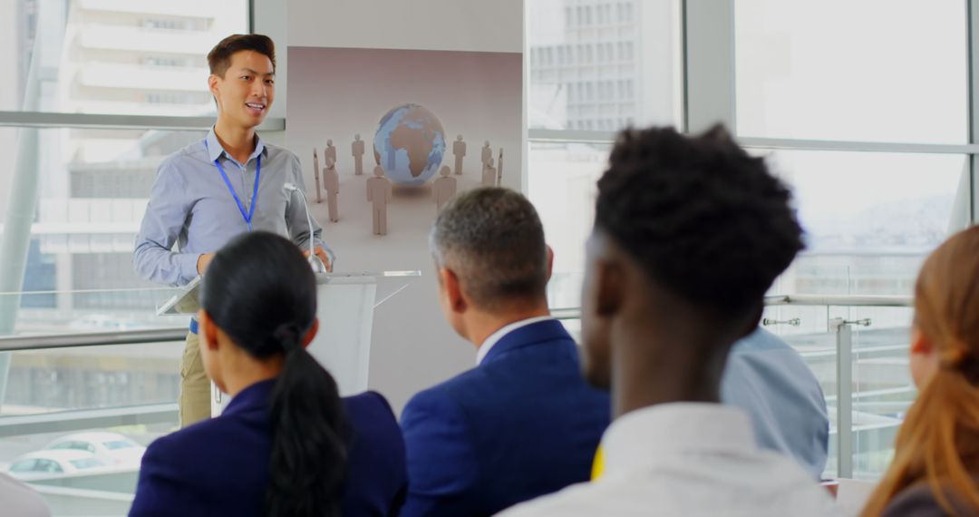 Confident Speaker Presenting at Business Seminar with Audience Engagement