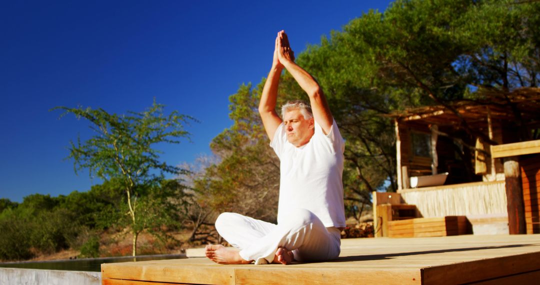 Senior Man Practicing Mindful Yoga Outdoors on Wooden Deck - Free Images, Stock Photos and Pictures on Pikwizard.com