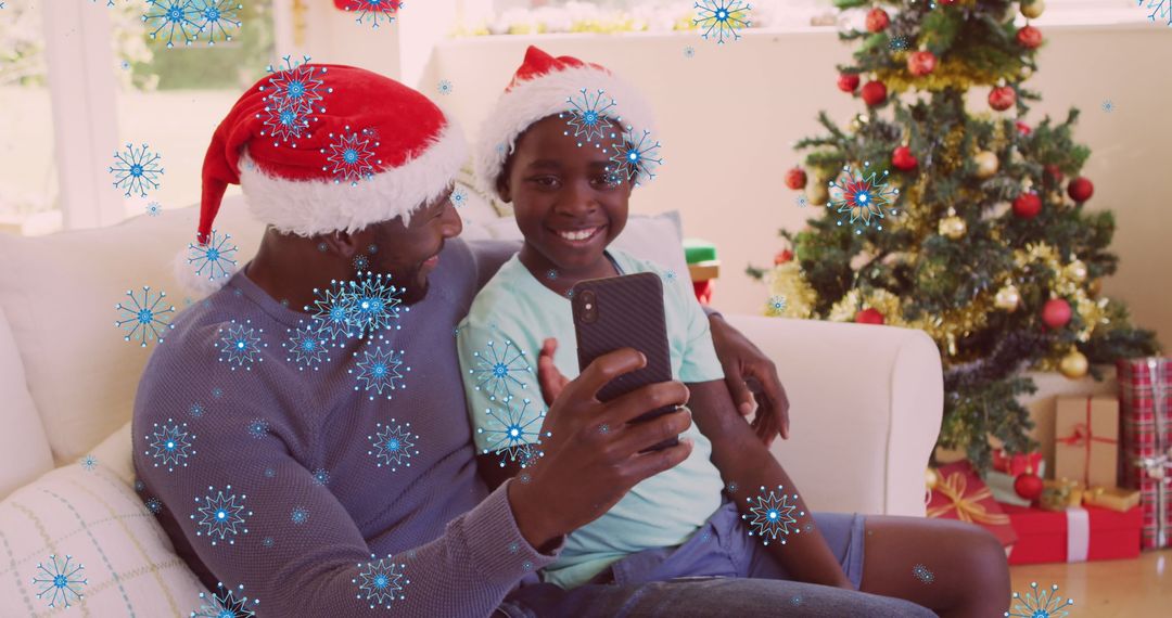Bonding African American Father and Son in Red Santa Hats Video Calling During Christmas