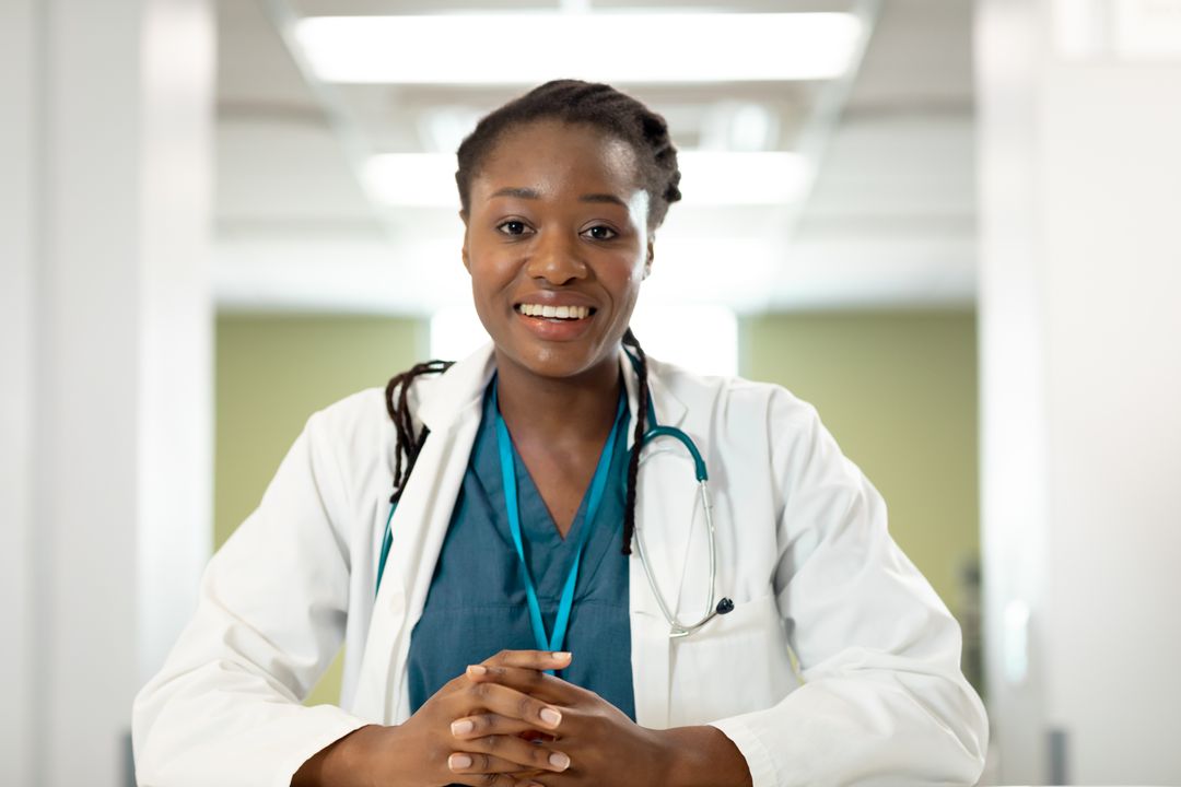 Smiling African American Female Doctor Conducting Video Call Consultation - Free Images, Stock Photos and Pictures on Pikwizard.com