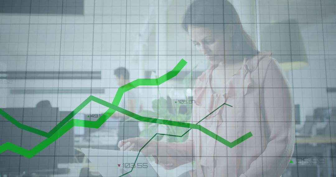 Businesswoman Analyzing Financial Graphs on Tablet
