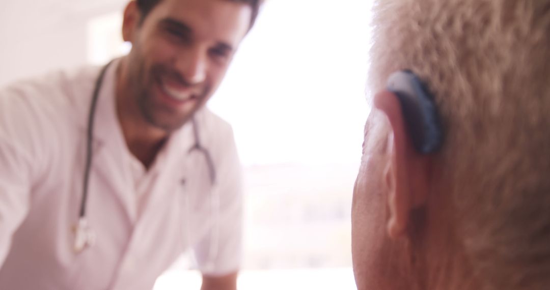 Doctor Assisting Senior Patient with Hearing Aid - Free Images, Stock Photos and Pictures on Pikwizard.com