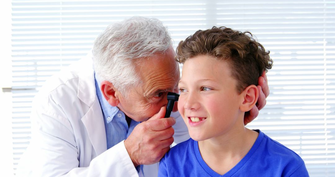 Doctor Examining Boy's Ear With Otoscope in Medical Office - Free Images, Stock Photos and Pictures on Pikwizard.com