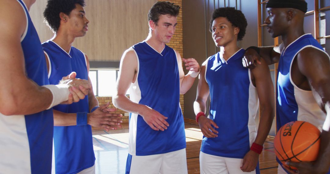 Diverse Basketball Team Having Strategy Discussion on Court - Free Images, Stock Photos and Pictures on Pikwizard.com