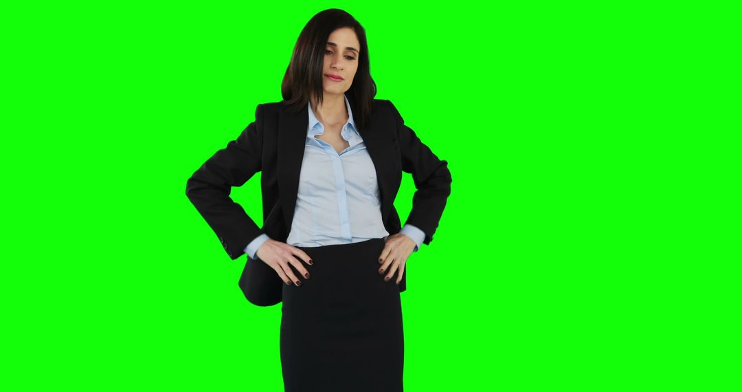 Confident Businesswoman Standing with Hands on Hips on Green Screen Background - Free Images, Stock Photos and Pictures on Pikwizard.com