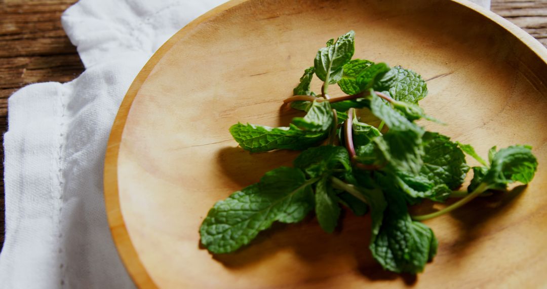 Fresh Mint Leaves in Wooden Bowl on Rustic Table - Free Images, Stock Photos and Pictures on Pikwizard.com