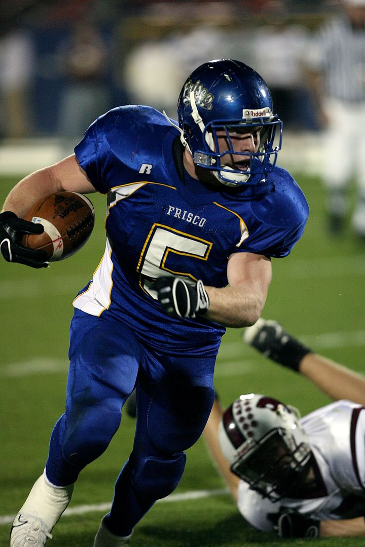 Football Player Running with Ball During Game - Free Images, Stock Photos and Pictures on Pikwizard.com