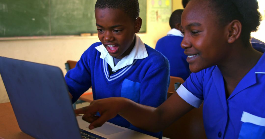 African Students Collaborating on Laptop in Classroom