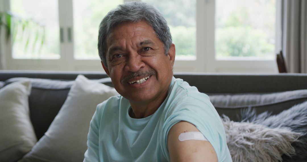 Smiling Elderly Man Showing Bandage After Vaccination - Free Images, Stock Photos and Pictures on Pikwizard.com