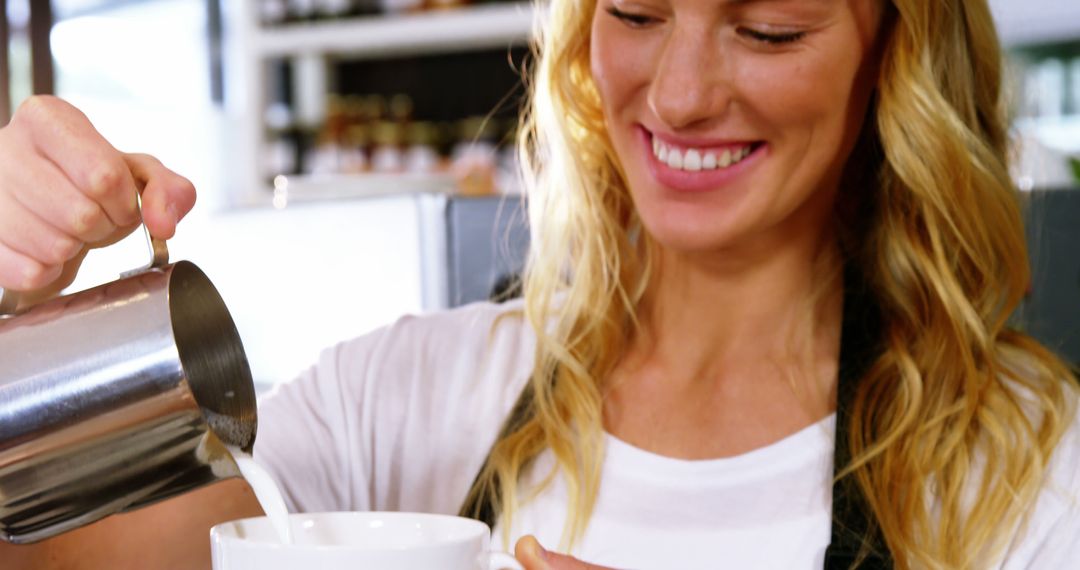 Smiling Woman Pouring Milk at Coffee Shop - Free Images, Stock Photos and Pictures on Pikwizard.com