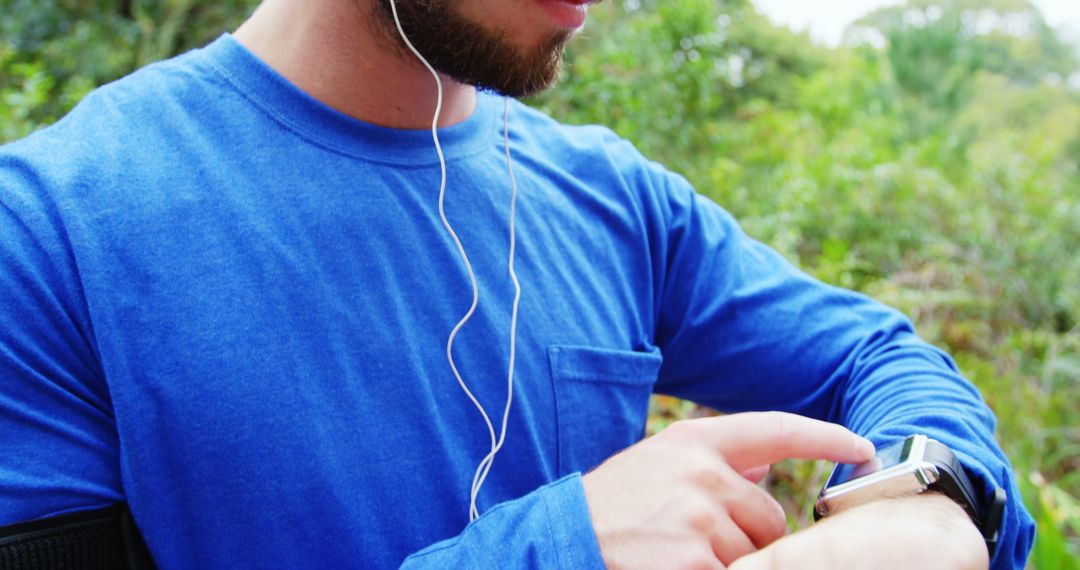 Man Using Smartwatch While Exercising Outdoors - Free Images, Stock Photos and Pictures on Pikwizard.com