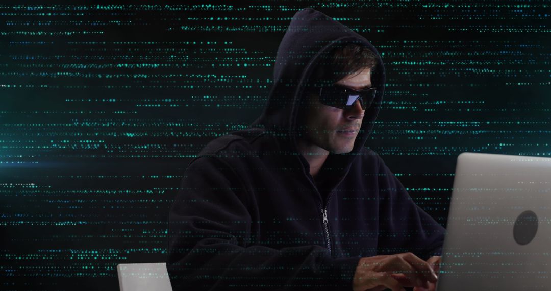 Male Hacker in Dark Hoodie Engaged in Cyber Activities