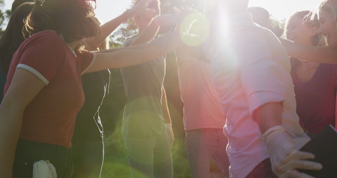 Friends Celebrating Success with High Fives in outdoor Sunlight - Free Images, Stock Photos and Pictures on Pikwizard.com