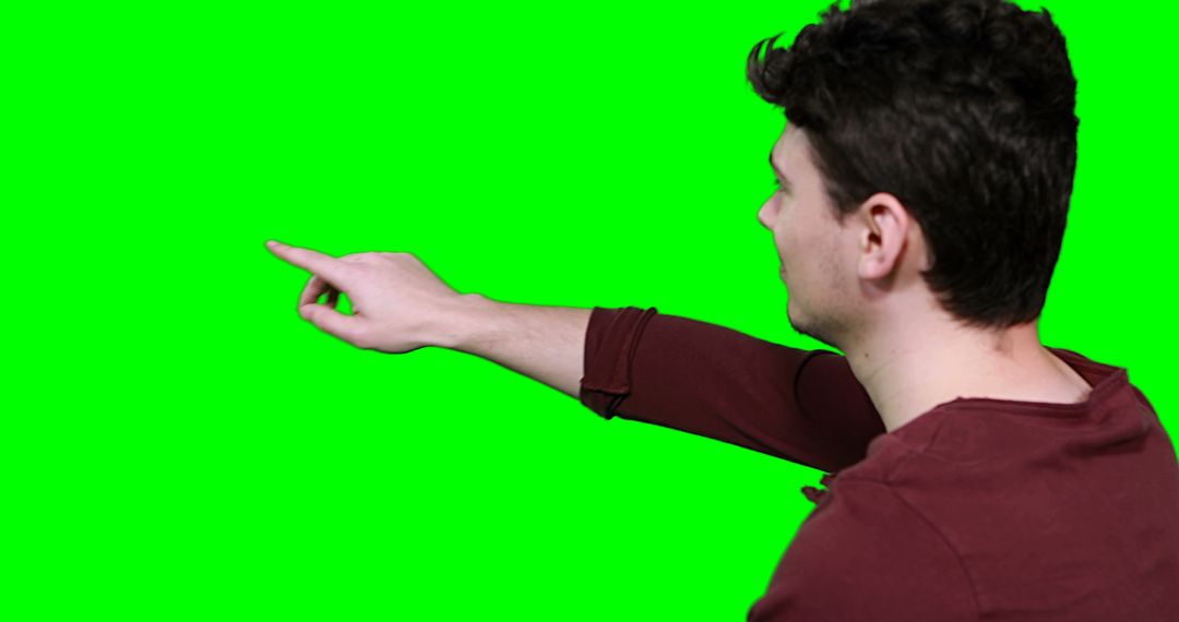 Man pointing right over green chroma key background - Free Images, Stock Photos and Pictures on Pikwizard.com