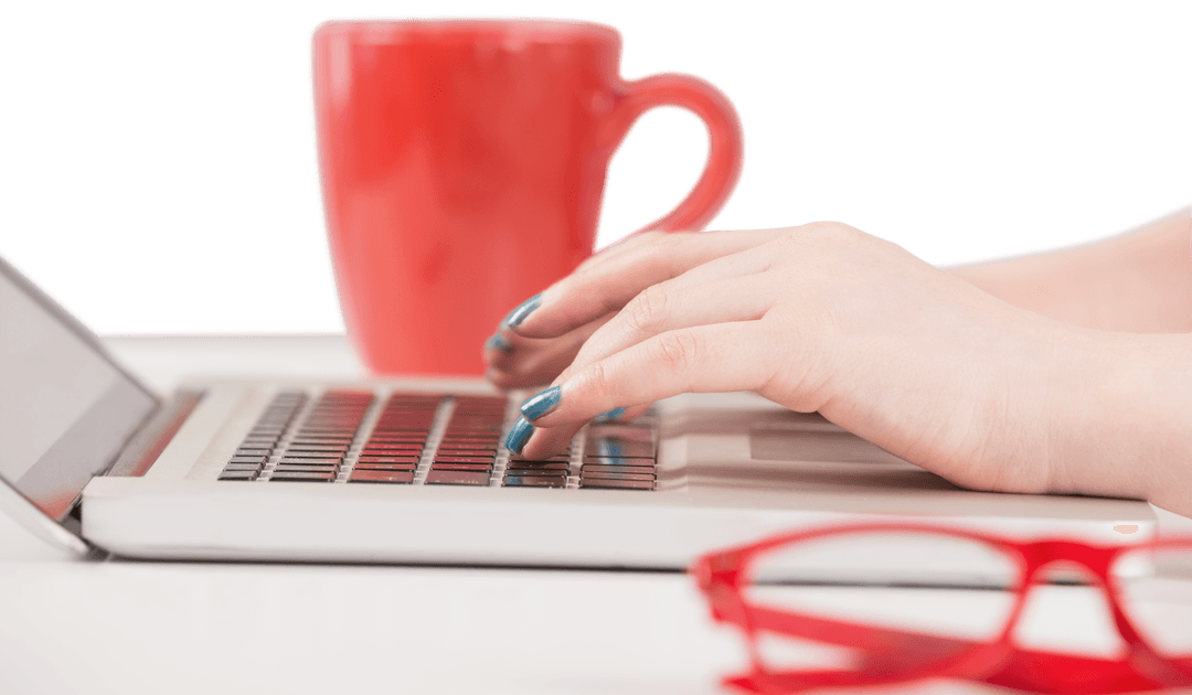 Female Hands Typing on Laptop with Transparent Mug and Glasses