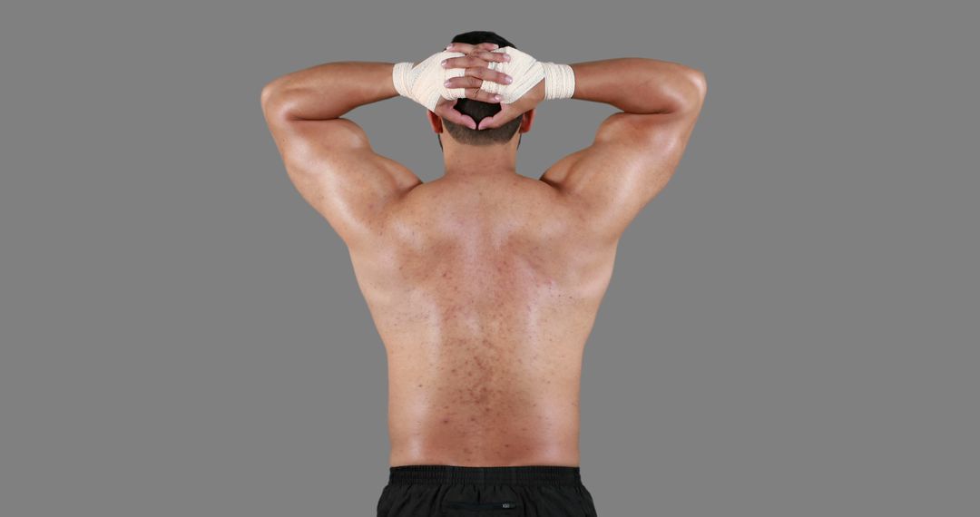 Athletic Male Showcasing Muscular Back and Resting Pose