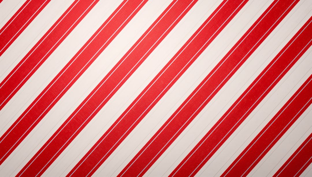 Diagonal Red and Cream Striped Pattern with Subtle Texture for Retro Candy-Stripe Designs