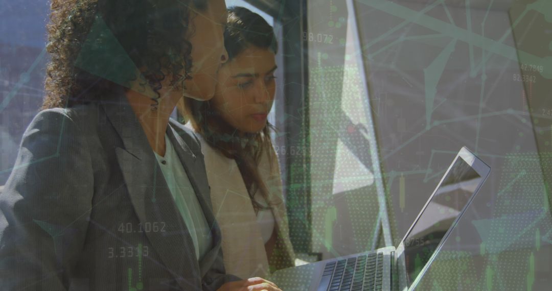 Business Professionals Analyzing Data on Laptop in Modern Office