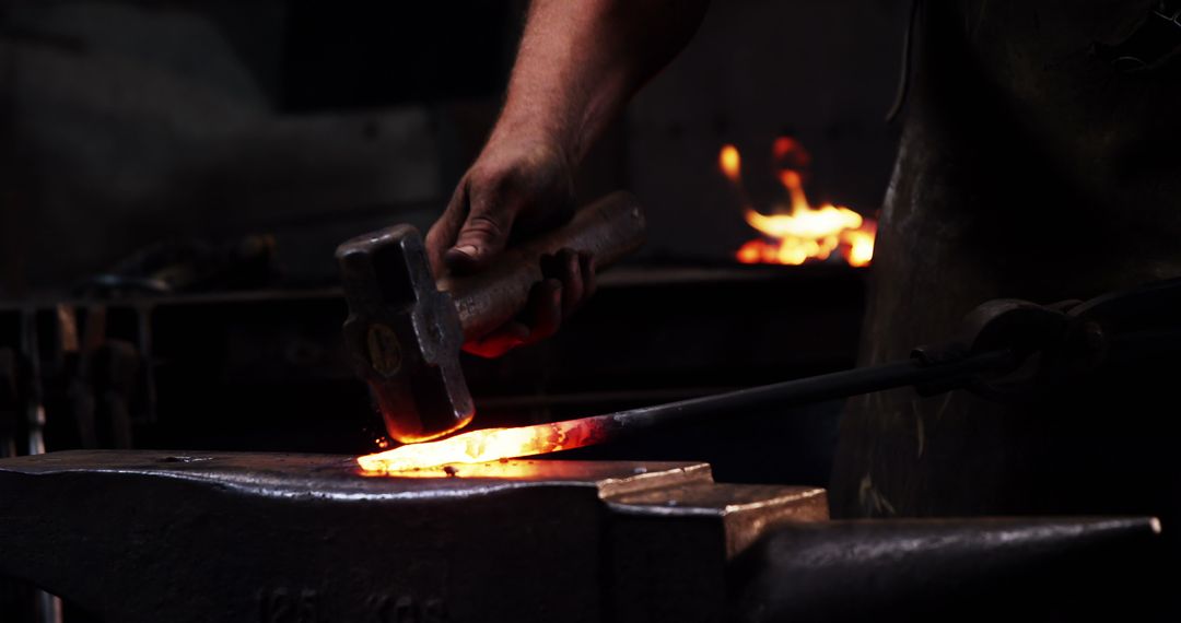 Blacksmith Forging Metal with Hammer and Anvil in Workshop - Free Images, Stock Photos and Pictures on Pikwizard.com