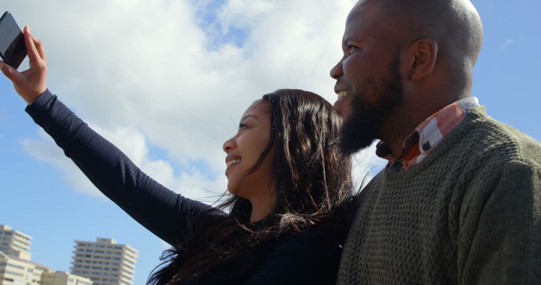 Happy Couple Taking Selfie Outdoors with City Skyline Background - Free Images, Stock Photos and Pictures on Pikwizard.com