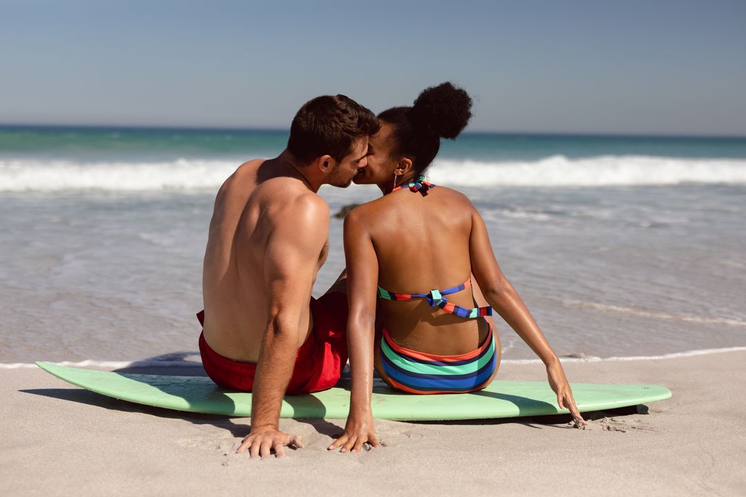 Romantic Couple Kissing on Surfboard at Beach - Free Images, Stock Photos and Pictures on Pikwizard.com