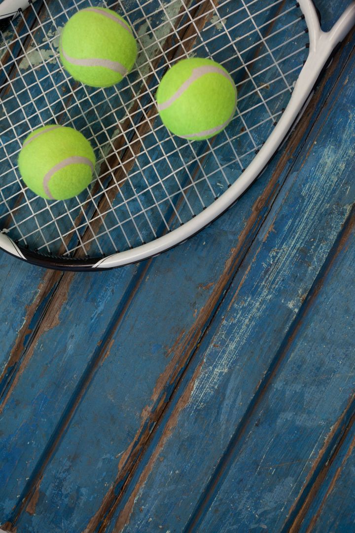 High angle view of fluorescent yellow balls on tennis racket - Free Images, Stock Photos and Pictures on Pikwizard.com