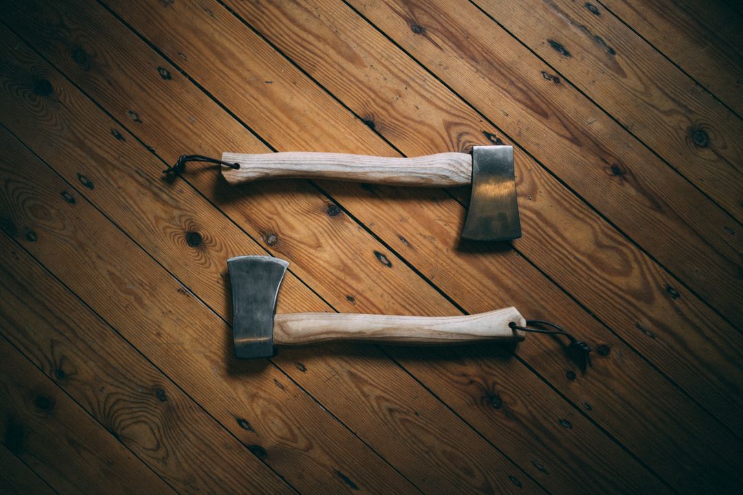 Two Wooden Handled Axes on Rustic Wooden Floor - Free Images, Stock Photos and Pictures on Pikwizard.com