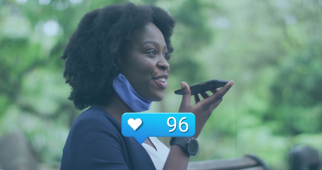 Woman Using Smartphone with Face Mask Outdoors, Displaying Like Icon