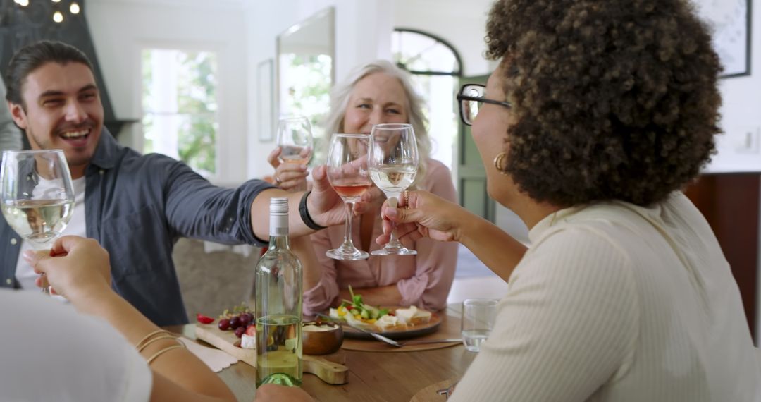 Friends Celebrating with Wine Around Dining Table