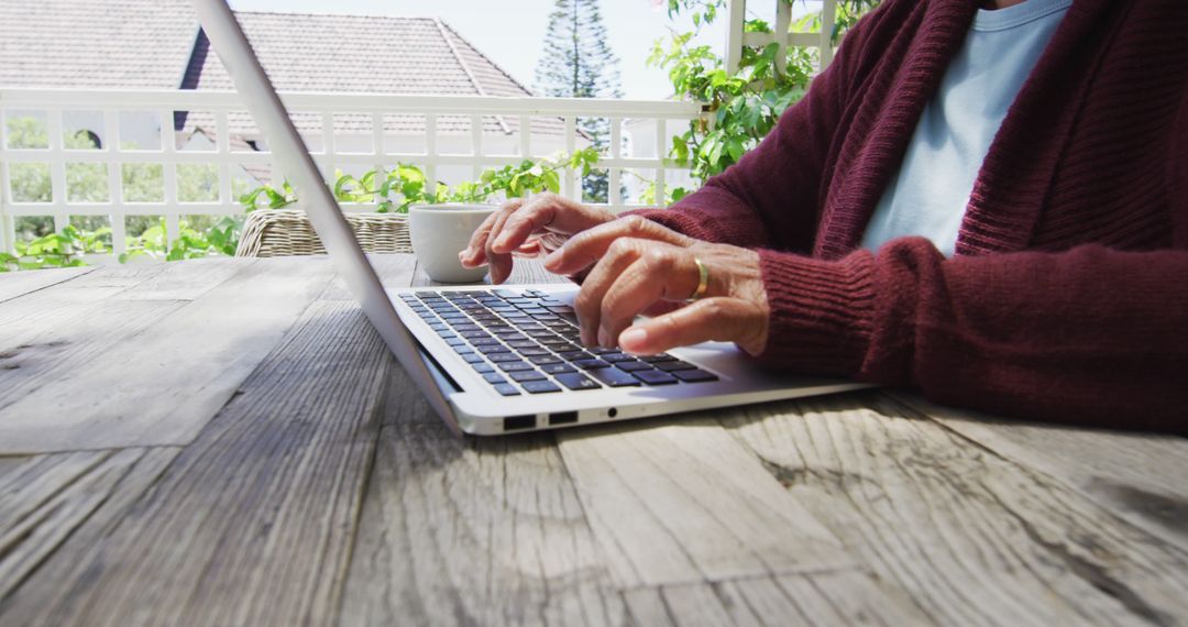 Senior Using Laptop on Outdoor Terrace with Coffee Cup - Free Images, Stock Photos and Pictures on Pikwizard.com