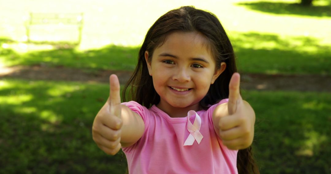 Cheerful Young Girl Supporting Breast Cancer Awareness Outdoors - Free Images, Stock Photos and Pictures on Pikwizard.com