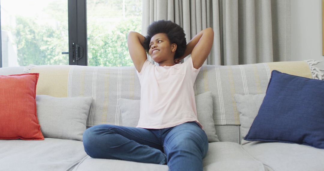 Relaxed Woman Sitting on Couch at Home - Free Images, Stock Photos and Pictures on Pikwizard.com