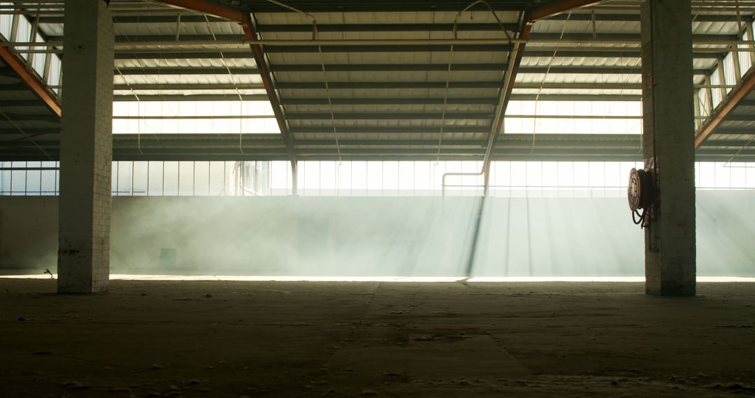 Ethereal Sunlight Beams in Empty Industrial Warehouse - Free Images, Stock Photos and Pictures on Pikwizard.com