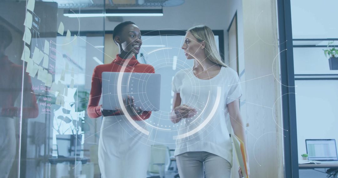 Businesswomen Advancing with Augmented Reality in Modern Office