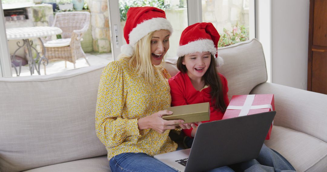 Mother and Daughter in Santa Hats Enjoy Virtual Christmas Celebration - Free Images, Stock Photos and Pictures on Pikwizard.com