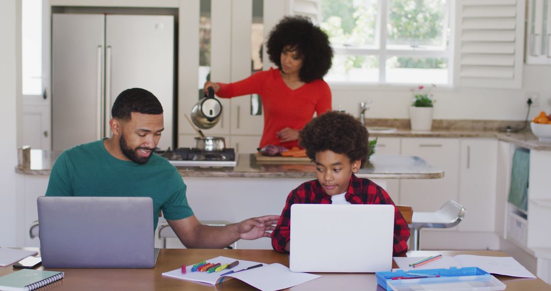 Father and Son Remote Learning in Modern Kitchen Setting