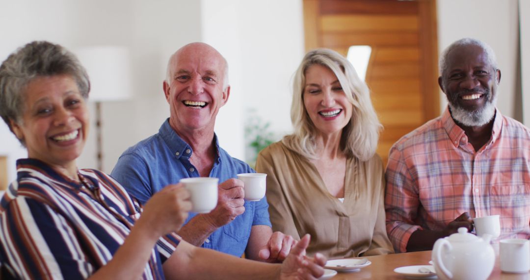 Diverse Group of Senior Friends Enjoying Tea Together Indoors - Free Images, Stock Photos and Pictures on Pikwizard.com