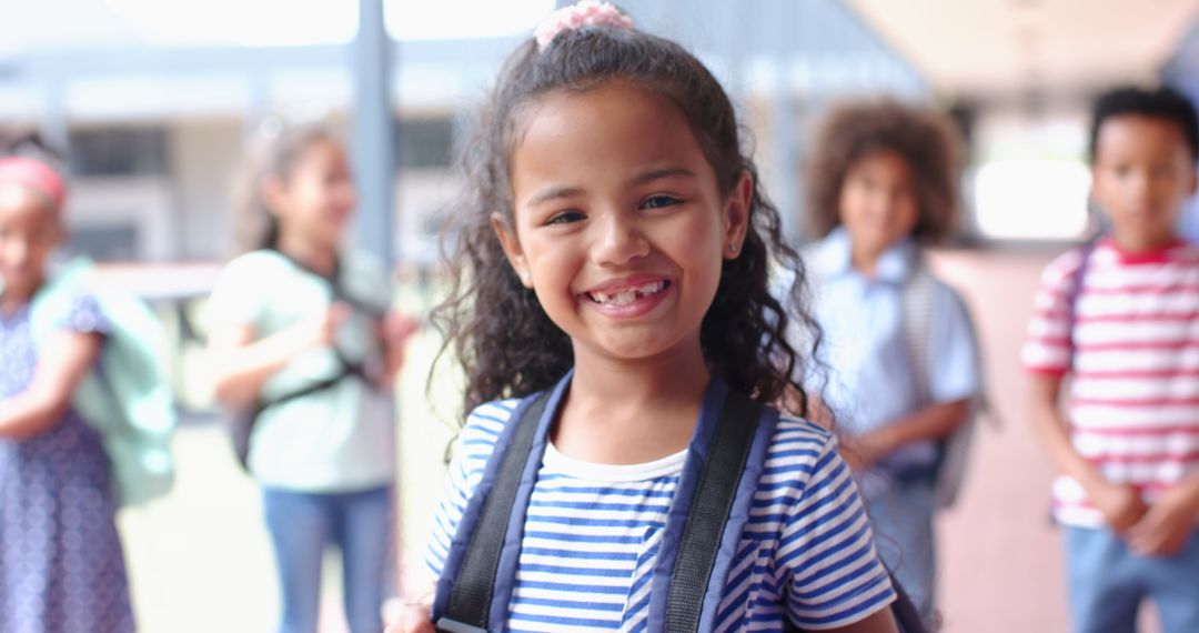 Cheerful Schoolgirl with Backpack Surrounded by Diverse Classmates