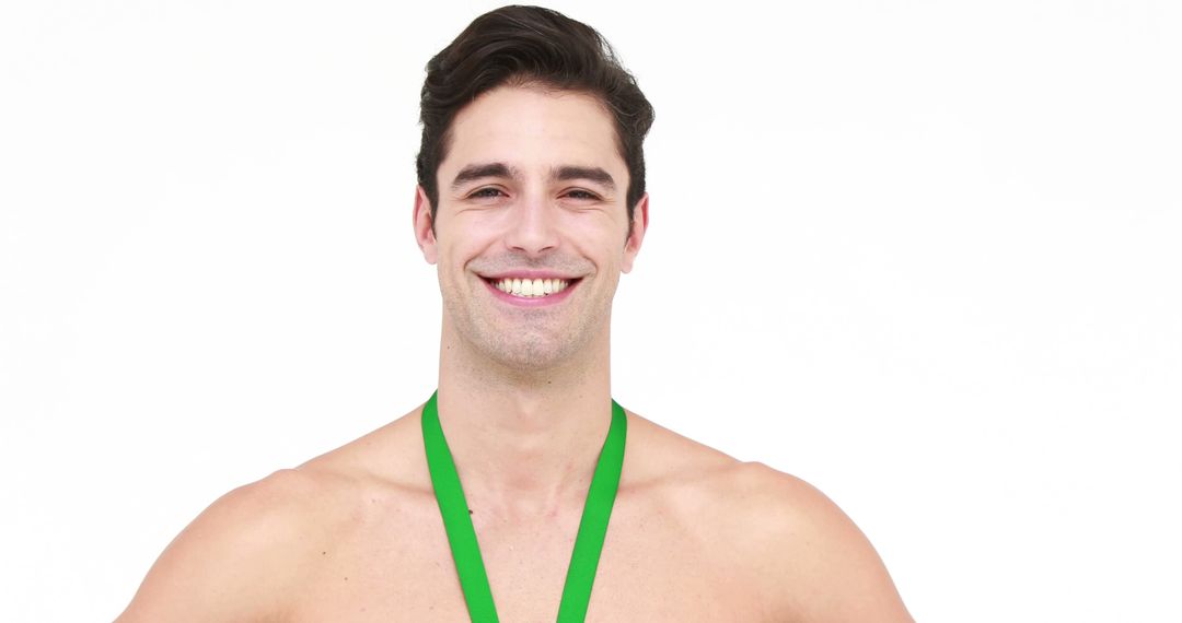 Smiling Shirtless Young Man with Green Medal Against White Background - Free Images, Stock Photos and Pictures on Pikwizard.com