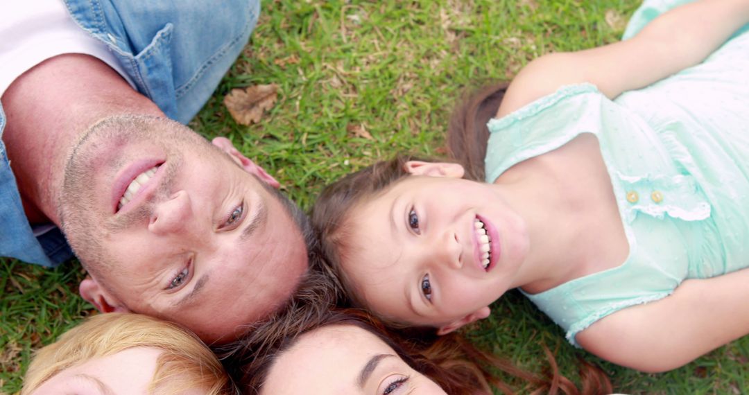 Family Lying on Grass Smiling Cheerfully - Free Images, Stock Photos and Pictures on Pikwizard.com