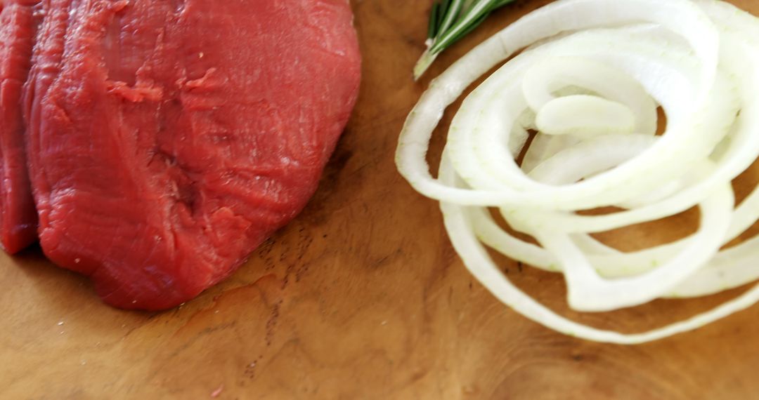 Fresh Raw Beef with Onion Slices on Wooden Board - Free Images, Stock Photos and Pictures on Pikwizard.com