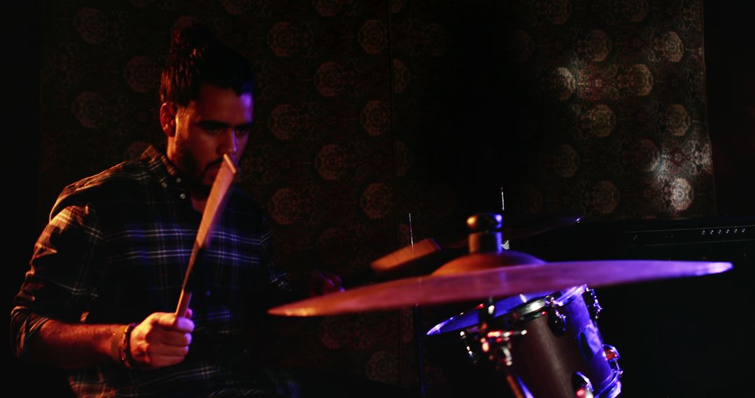 Young Musician Playing Drums in Dimly Lit Room - Free Images, Stock Photos and Pictures on Pikwizard.com