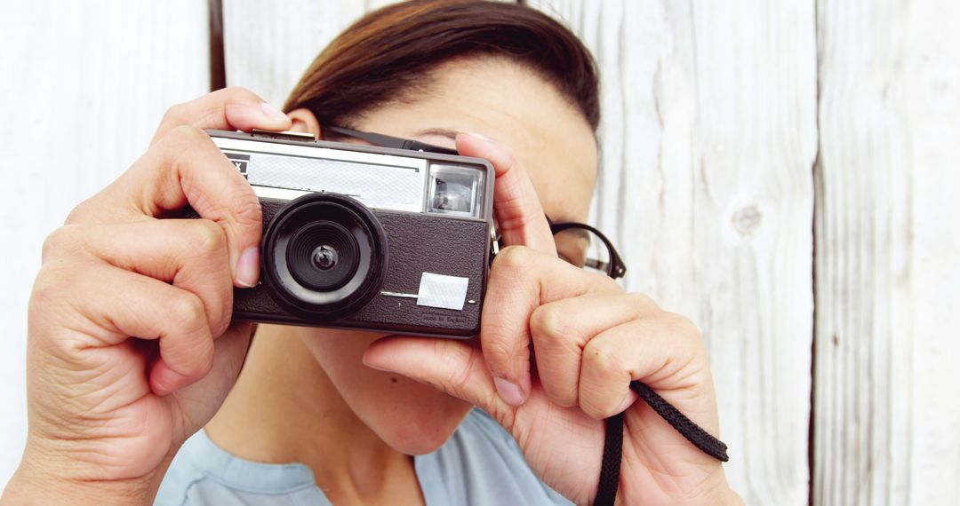 Person Using Vintage Camera Taking Photo Outdoors - Free Images, Stock Photos and Pictures on Pikwizard.com