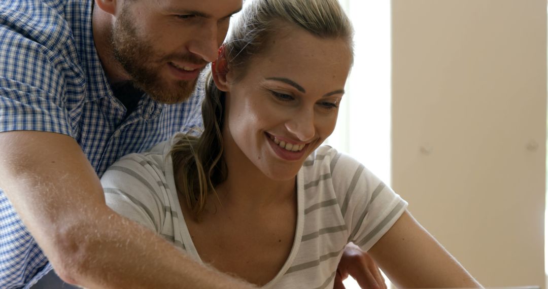 Smiling Couple Collaborating on Project at Home - Free Images, Stock Photos and Pictures on Pikwizard.com