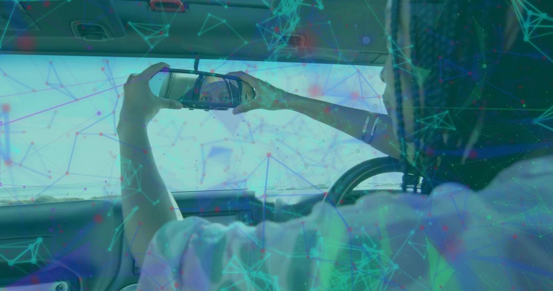 Woman Using Smartphone Checking Mirror in Car Interior with Technology Overlay