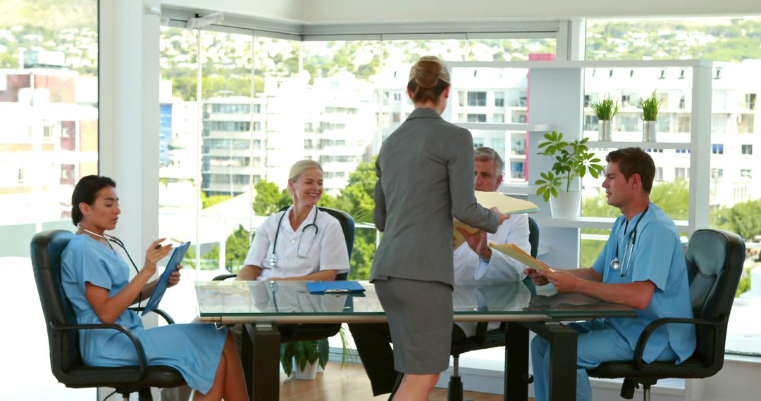 Medical Team Discussing Reports in Modern Office - Free Images, Stock Photos and Pictures on Pikwizard.com