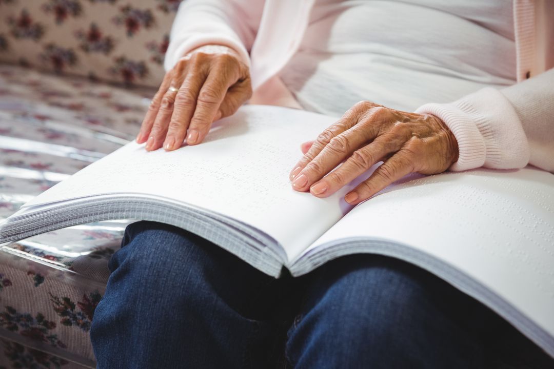 Senior Woman Reading Braille Book in Retirement Home - Free Images, Stock Photos and Pictures on Pikwizard.com