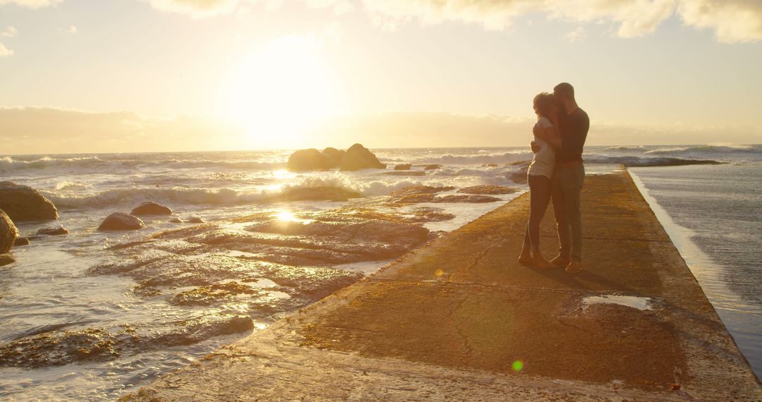 Romantic Couple Embracing at Ocean Sunset on Seaside Walkway - Free Images, Stock Photos and Pictures on Pikwizard.com