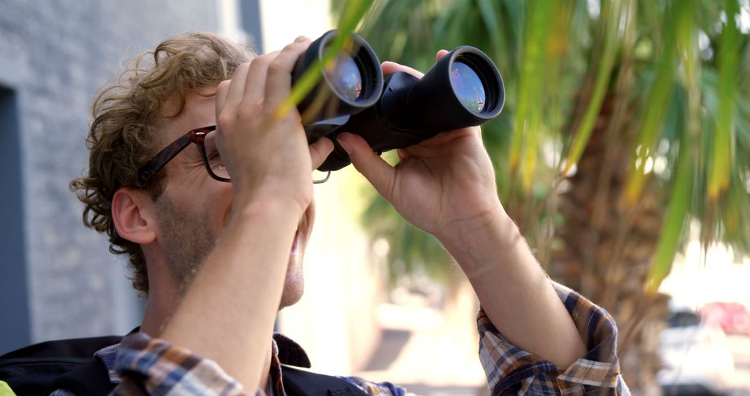 Man With Binoculars Outdoors Observing Surroundings - Free Images, Stock Photos and Pictures on Pikwizard.com